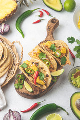 Mexican cuisine - mexican tacos al pastor, pork meat, corn tortillas, chili pepper, pineapple, avocado, cilantro, lime