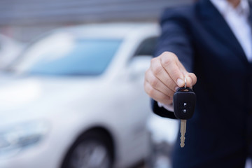 Salesman is carrying the car keys