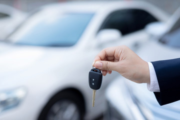 Salesman is carrying the car keys