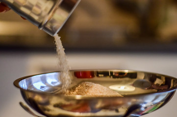 measuring sugar to prepare cookies dough close up