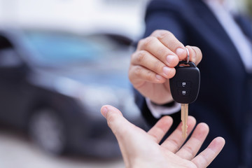 Salesman is carrying the car keys