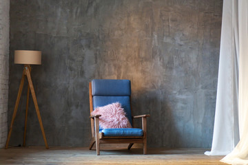 Minimalist interior design. Armchair and lamp on wall background