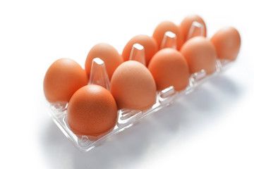 Eggs in box on white background