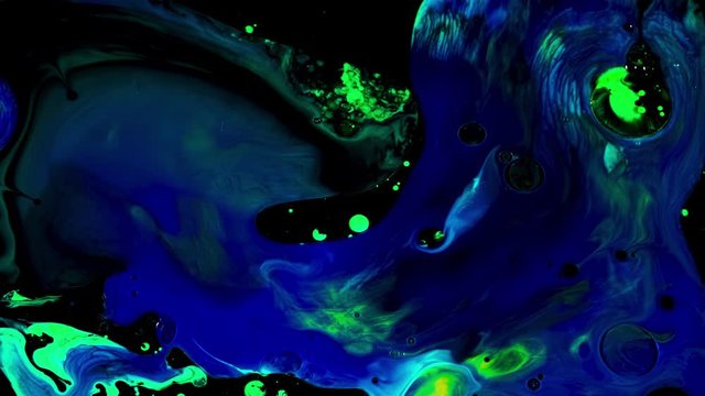 Fluid art background with colorful tints liquid surface. Stock footage. Amazing effect of acrylic paints on black canvas, mixing different bright colors.