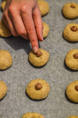 decorating cookies with an hazelnut before baking close up