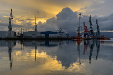 Fototapeta na wymiar beautiful sunset over seaport dramatic landscape