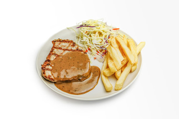 Grill pork steak with creamy pepper sauce, served with Vegetable salads and French fries on white background