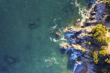 turquoise ocean with sea waves hitting at coast