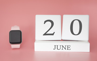 Modern Watch with cube calendar and date 20 june on pink background. Concept summer time vacation.