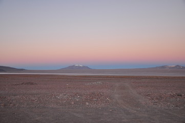 Fototapeta na wymiar sunset in Bolivian desert snowy mountain 