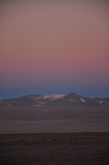 sunset in Bolivian desert snowy mountain 