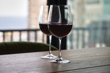 Luxury red wine. Delicious drinks, made from delicious grapes in wine glass on the table. restaurant close up. red wine on table. plate with wine on table. restaurant open. catering industry