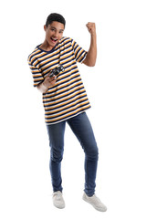 African-American teenage boy playing video game on white background