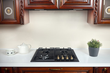 Interior of modern kitchen in classic style with golden elements cherry alder wood cabinetry with...