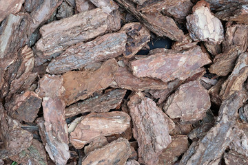 natural pine bark, wood chips top view. Decorative materials for the design of flower beds, landscape design. tree bark for flower beds. Coniferous mulch of brown color