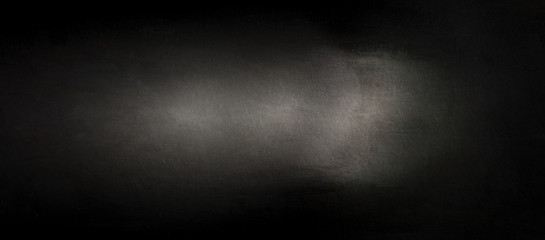 Fototapeta premium Panoramic light falling on black wood texture. Close up panorama of a wooden chipboard surface. 