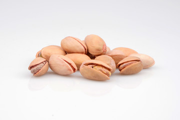 A handful of organic pistachios in white background