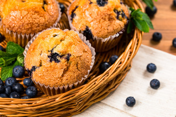 Blueberry Muffins with Fresh Blueberries on Wooden Background. Selective focus.