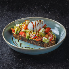 Open-faced avocado and eggs sandwich