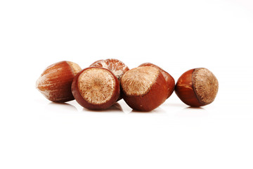 Organic and fresh hazelnuts together on white background