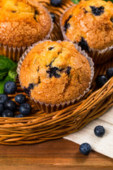 Blueberry Muffins with Fresh Blueberries on Wooden Background. Selective focus.