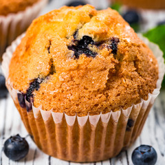 Blueberry Muffins with Fresh Blueberries on Wooden Background. Selective focus.