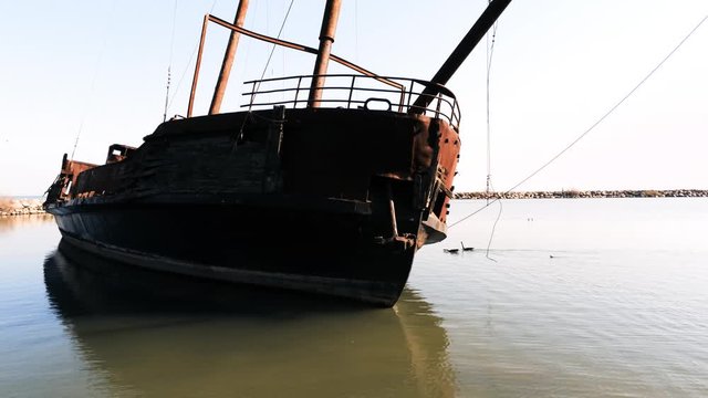 Drone vertical pan of shipwreck from mast down