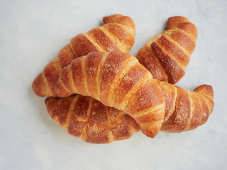 heap of a rustic artisan french croissants in a flat lay composition, close up view