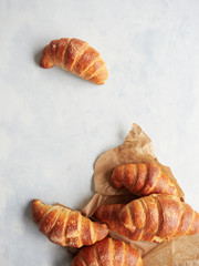 tradicional artisan croissants on wrapping paper ready to sell, blue blakgroun top view
