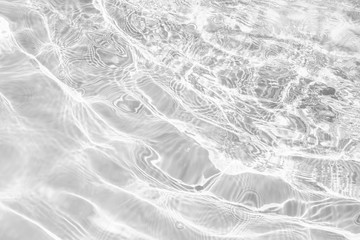 Closeup of desaturated transparent clear rough water surface texture with splashes and bubbles....