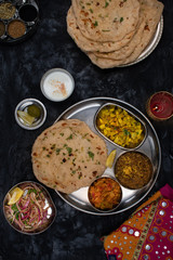 North Indian vegetarian  food served in thali style along with garlic butter naan