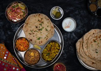 North Indian vegetarian  food served in thali style along with garlic butter naan