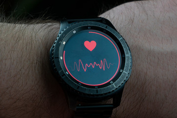 smart watch on hand measure blood pressure dark close-up background