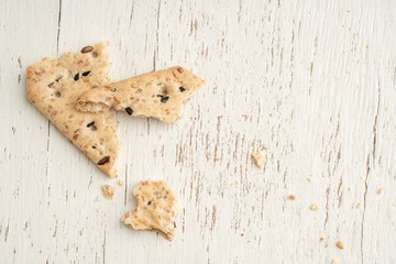 leftover crumbs of biscuits on a wooden table