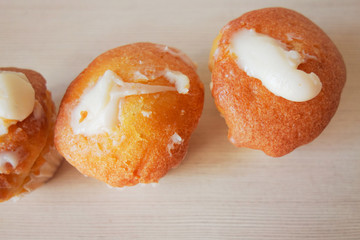 Muffin cakes dessert closeup view. Soft focus and blurred background of kitchen table. Homemade traditional baked food with morning coffee