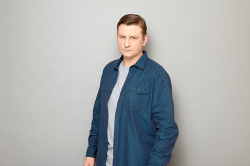 Portrait of serious focused mature man holding arms along body