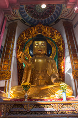 Buddha statue, Hong Kong. Beautiful vertical shot a this famous sitting religious figure! Made of gold. Prayers are welcome. 