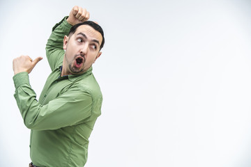 Creative teacher explains new material, gesticulating expressively and making grimaces.
