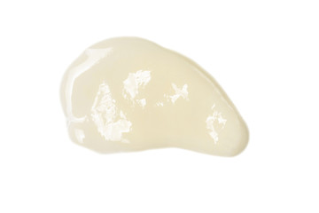 Smear of white moisturizer isolated on white background close-up