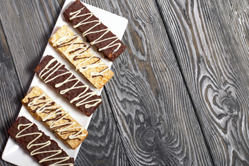 A plate with cookies in chocolate. Shot from above.