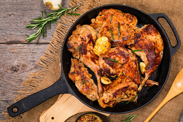 Braised Fried Rabbit with Rosemary, Garlic and Olive Oil on Wooden Background. Selective focus.
