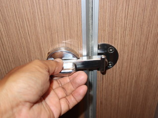Close-up of the hand opening the bathroom door