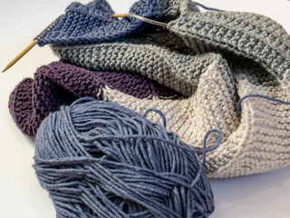 Close up wool colored knitting gold needle, kniting woolen texture, grey ball of woolen yarn