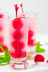 Raspberry Tequila Shots Lemonade Cocktail with Fresh Raspberry on White Background. Selective focus.