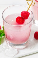 Raspberry Tequila Shots Lemonade Cocktail with Fresh Raspberry on White Background. Selective focus.