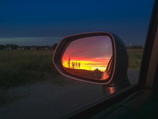 Fototapeta na wymiar Sunset in the rearview mirror