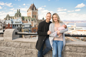 A Couple with baby in front of Chateau Frontenac at Quebec city Canada