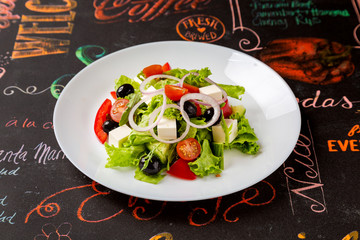 Fresh vegetable salad, healthy food in a plate on a table in a restaurant