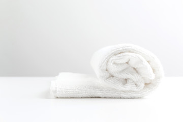 Fototapeta na wymiar A white towel is lying on a white table.