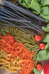 Assortment of different types of gluten-free penne pasta from chickpeas, red lentils, peas